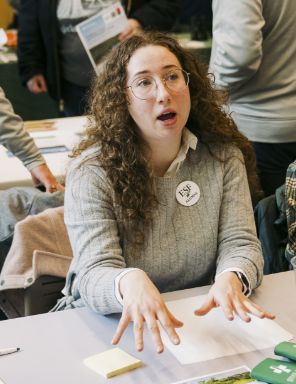 Person talking at a table.