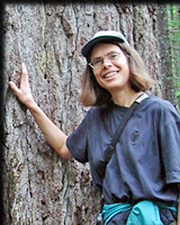 Catherine Landis leaning against a tree