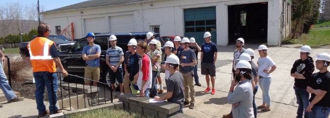 Students with hardhats listening to instructor