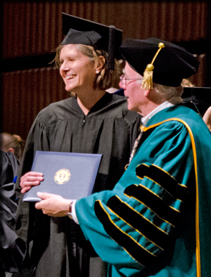 PRESIDENT MURPHY PRESENTING DEGREE TO SANDRA STEINGRABER
