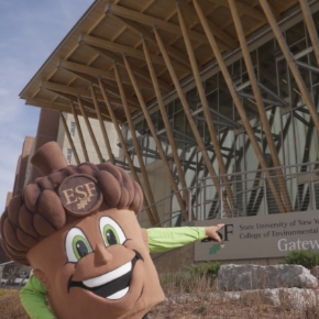 Photo of acorn mascot in front of Gateway building on ESF campus