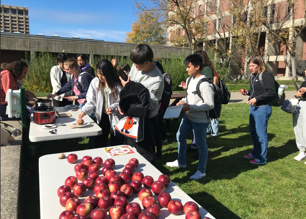 students waiting in line to dip apples in chocolate at campus crunch