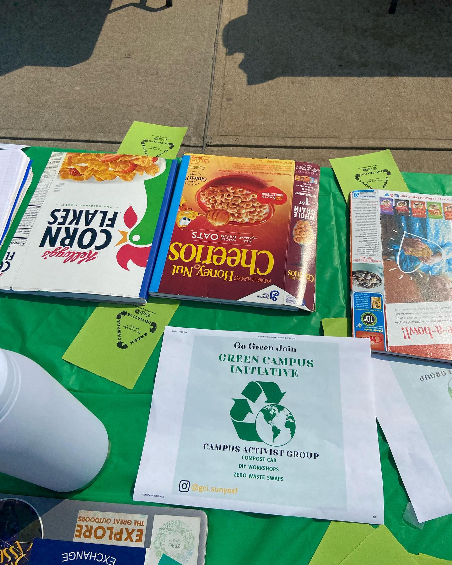 Notebooks made from upcycled cereal boxes shown laying on a table to promote GCI