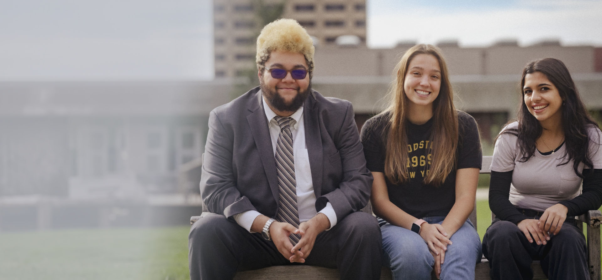 Three students seated on the ESF Quad