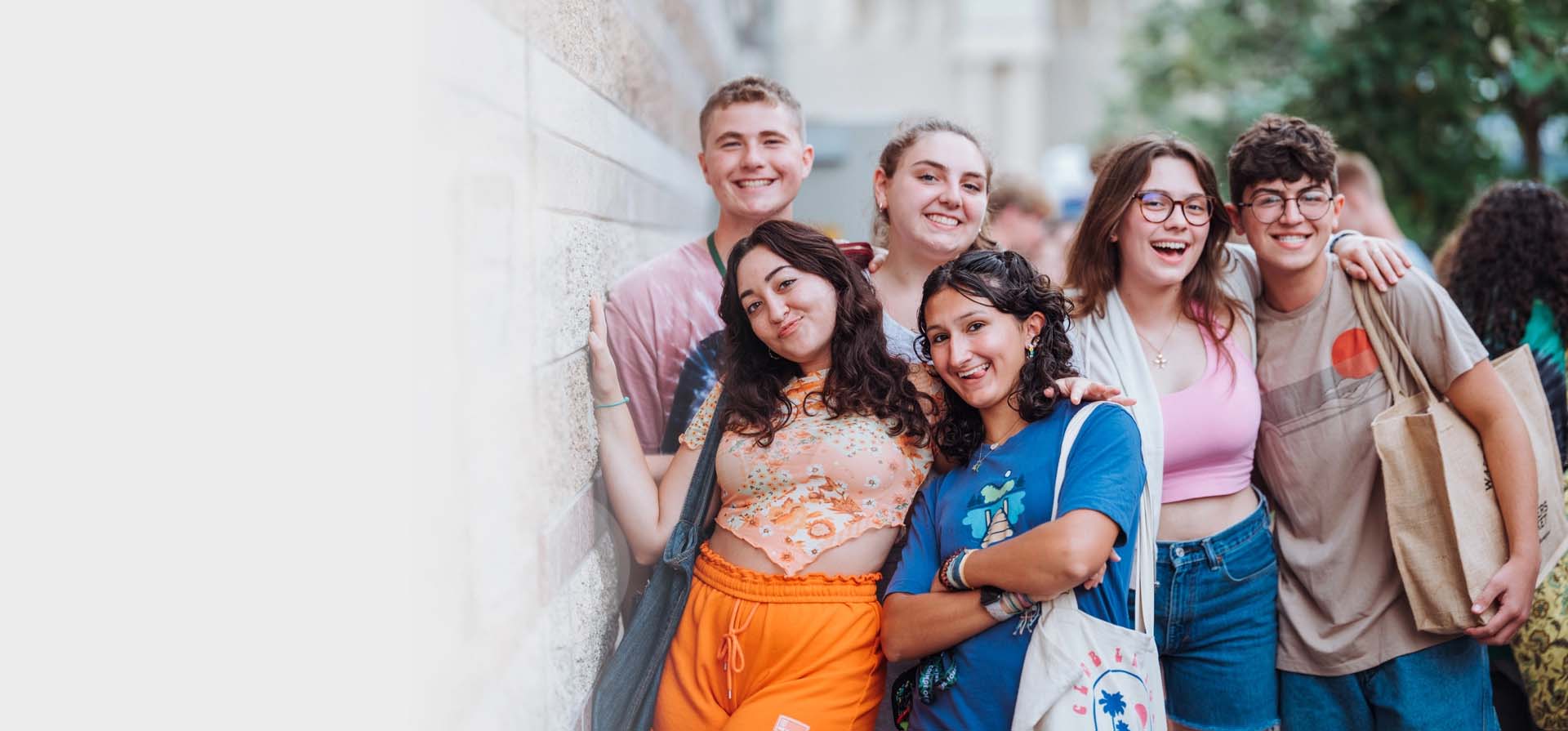 Students gathered next to a building.