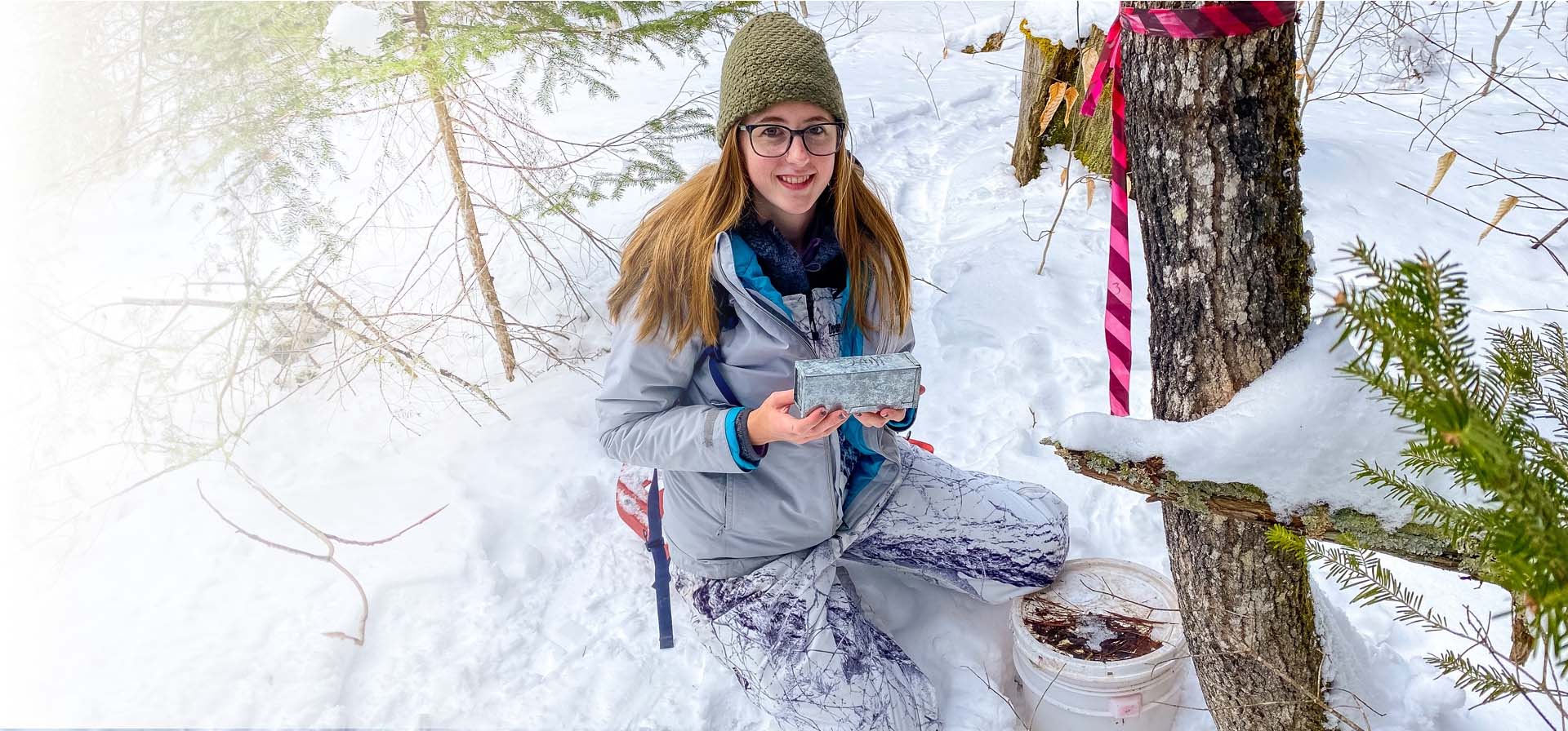 A student working with a trap as part of the Winter Mammalian Workshop.