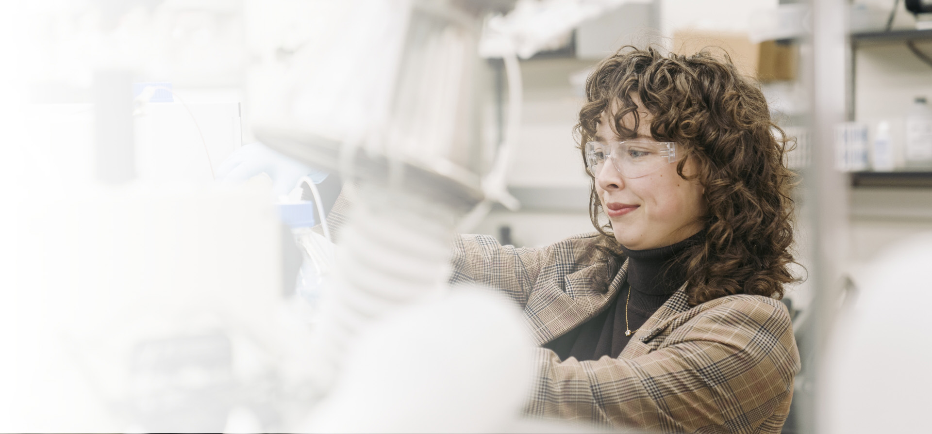 Student seated at laboratory equipment.