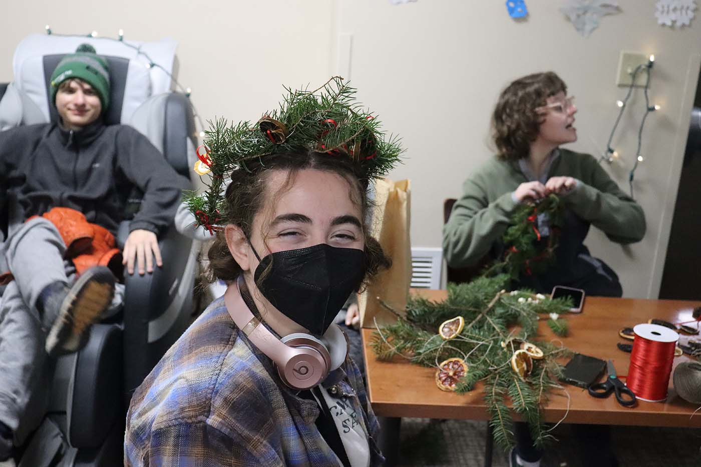 esf student holds up garland at winter event