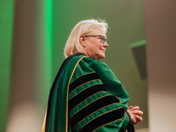 ESF President Joanie Mahoney stands in commencement regalia.