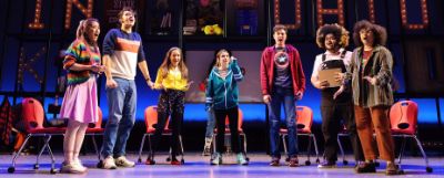 Cast of a production on a stage.