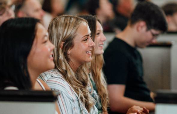 Students seated in an auditorium.