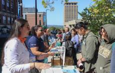 Students meet with employers at an outdoor table.