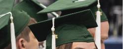 Graduating students wearing green caps.