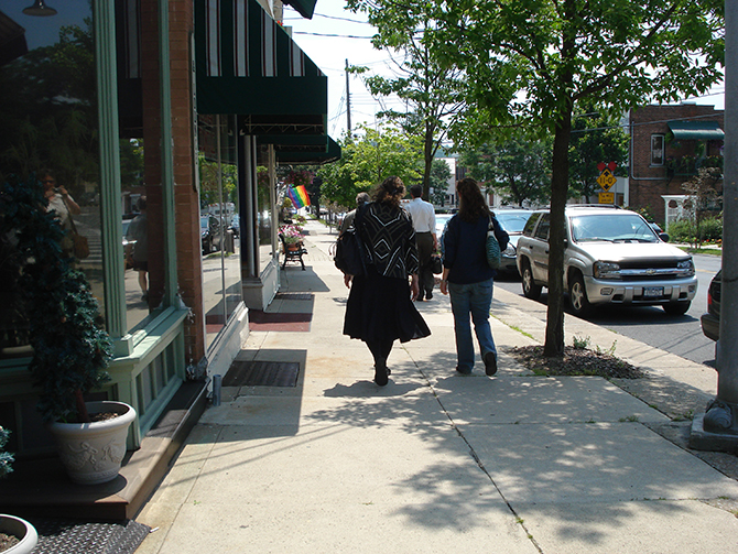 People walking down sidewalk