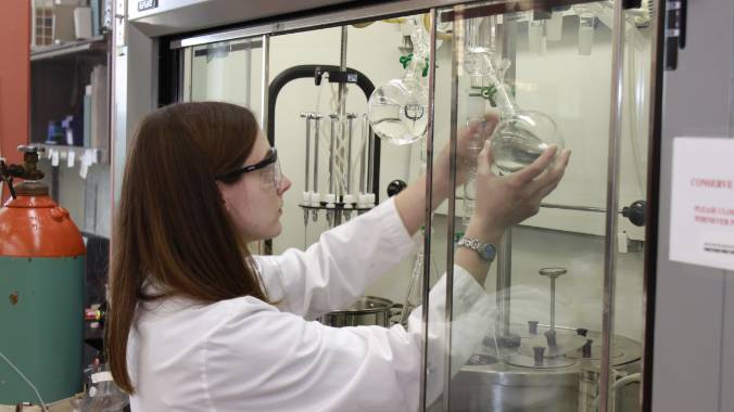 Student fills a vial in a laboratory