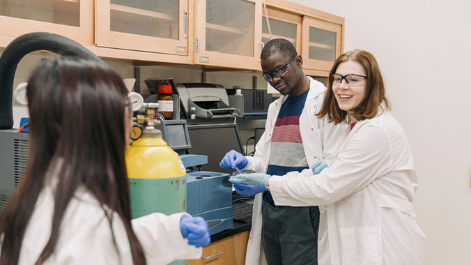 Students discussing proper technique for preparing samples.