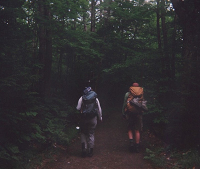 Kendal and Abby trail hiking. Both of them are carrying hiking backpacks