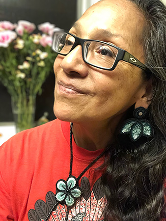 Leslie logan wearing a red tshirt and glasses.