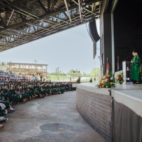 Students in caps and gowns at a past commencement.