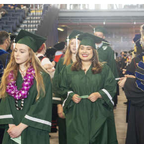 Graduates walking in regalia