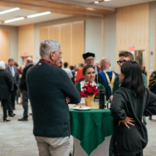 People standing around a reception table.