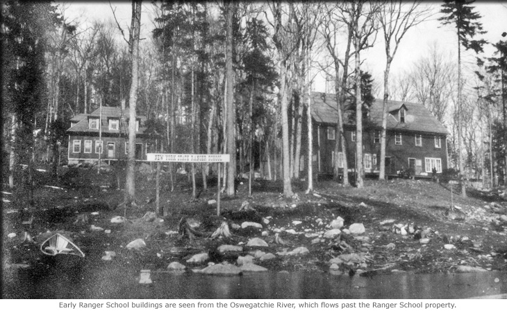 Early Ranger School buildings are seen from the Oswegatchie River, which flows past the Ranger School property.