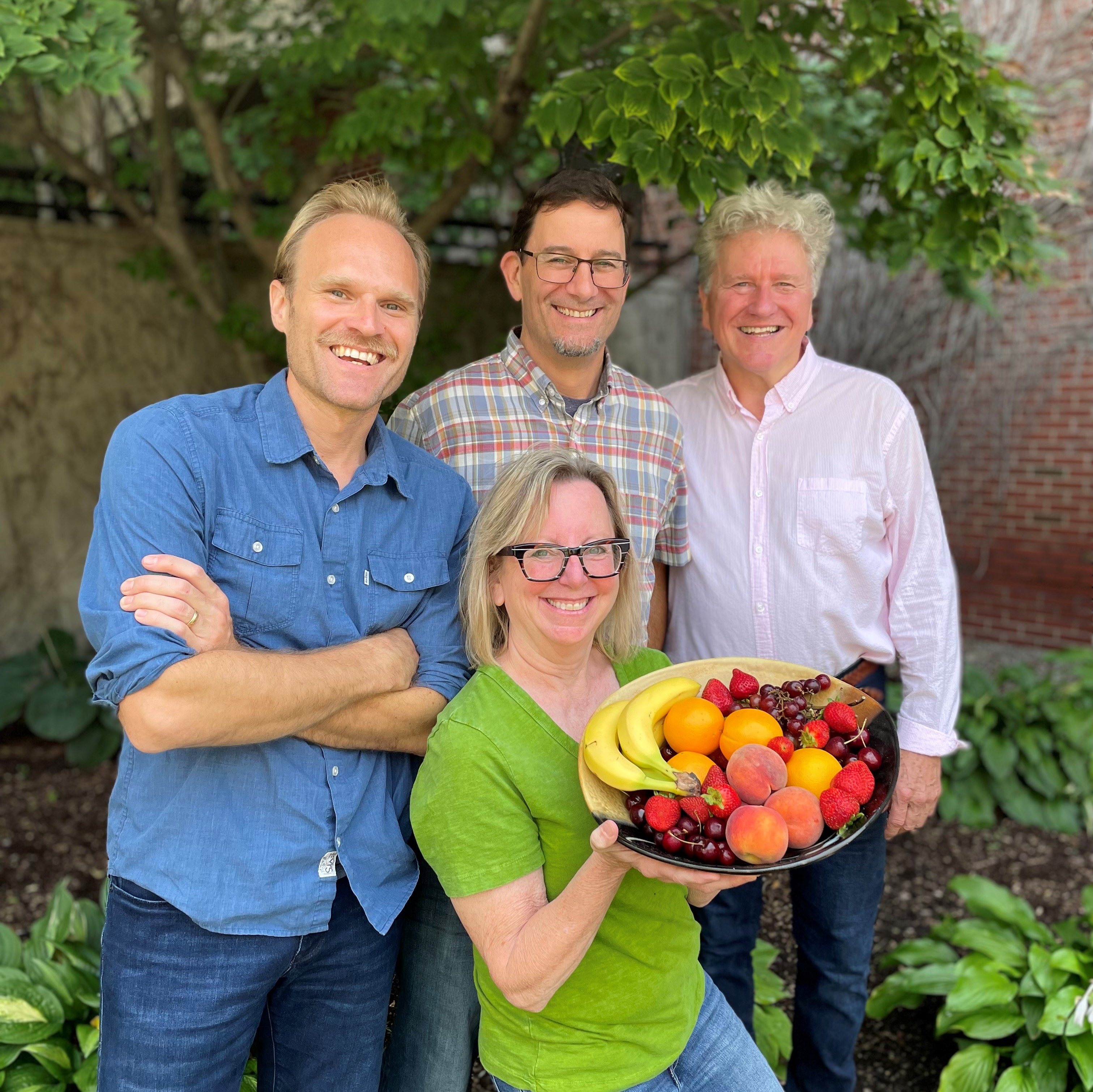 From left to right Tyler Dorholt, Jason Kohlbrenner, Tom McGarth, and Dr. Benette Whitmore, who is holding a plate of fruits.