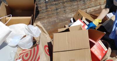 Cardboard boxes and plastic bags being sorted.