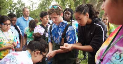 Students gathered working in the field.