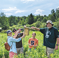 Chris Emerson and 3 other people in a field