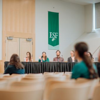 A panel addresses assembled students