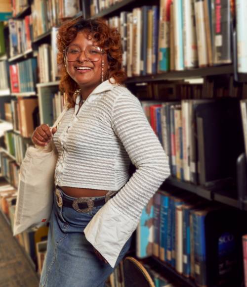 Person standing in a library.