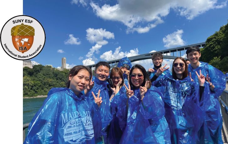 ESF ISA logo and a photo of students on a trip wearing ponchos by a river and bridge.