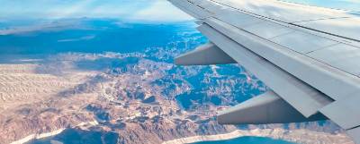 Photo looking out a plane window over a wing.