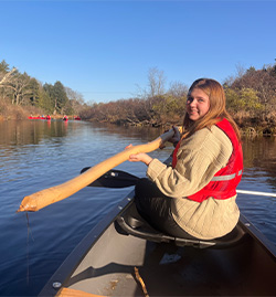 Alex Walls on a canoe holding an oar