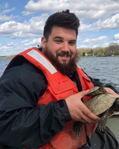 Bradley Thomas holding two turtles