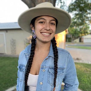 Jade morning sky little wearing a hat and jeans jacket