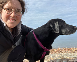 Sophie Brown holding a black dog