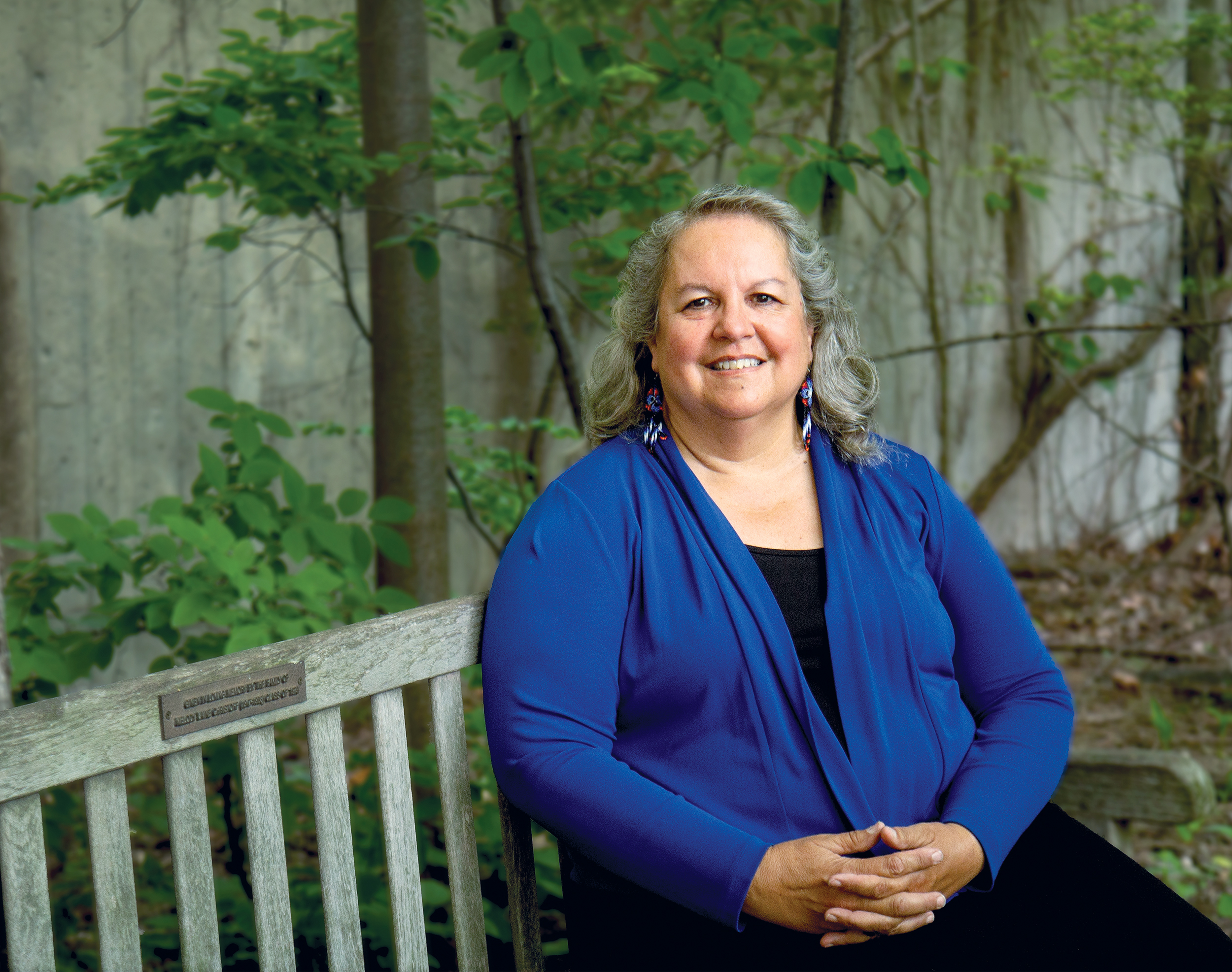 Robin Kimmerer siting on a bench