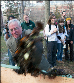 President Neil Murphy loads the first shovelful of food waste and leaves into the new aerating composter.