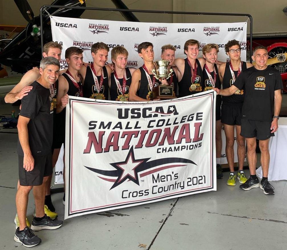 Men's cross country team with medals and cup after winning USCAA national title