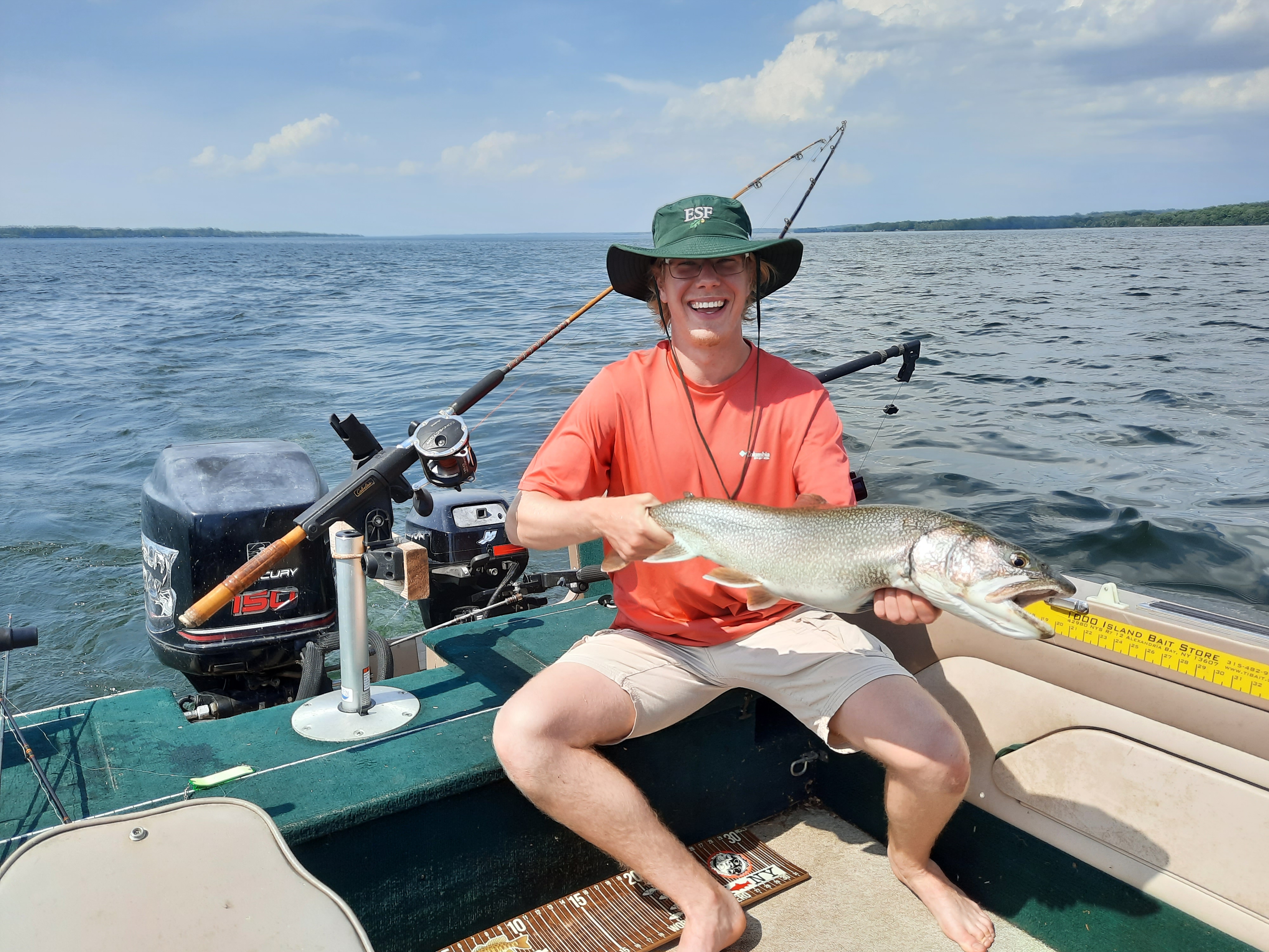 Conner Grant holding a fish on a boat