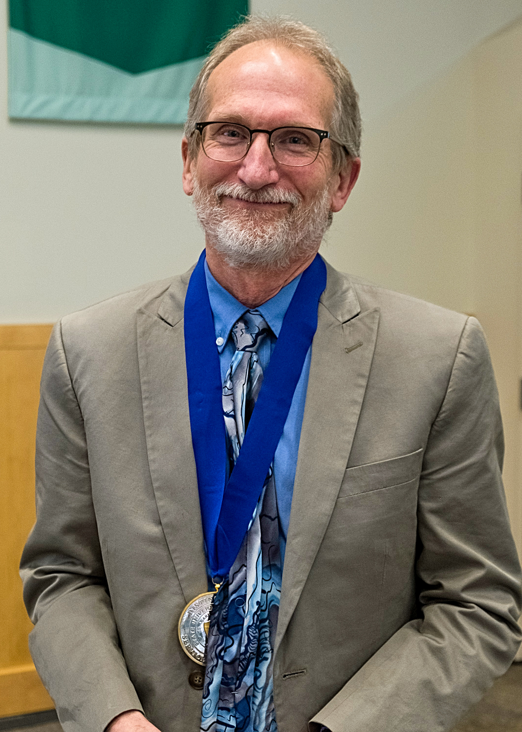 Douglas Johnston wearing his medal and smiling