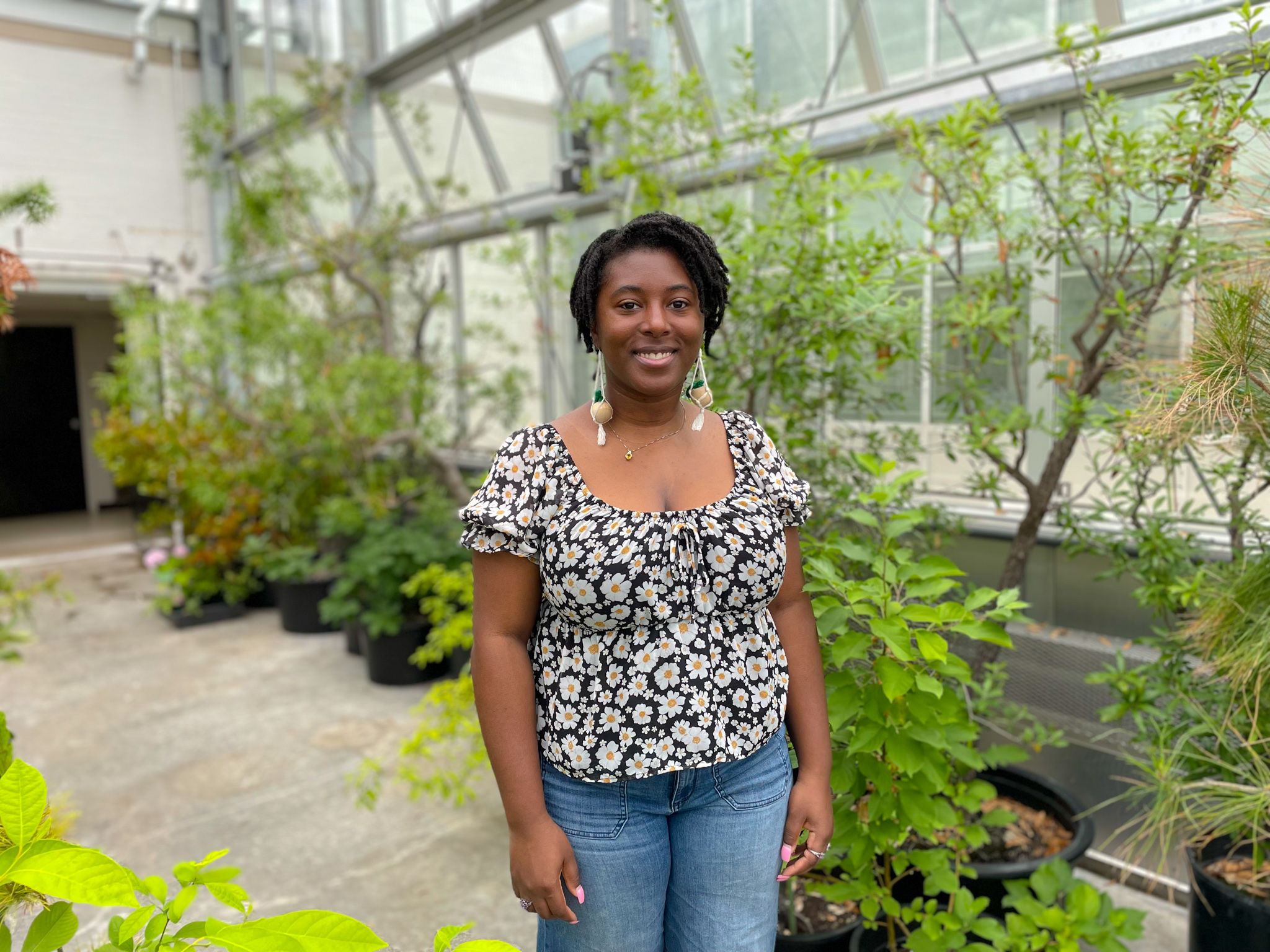Tatianna Moragne standing in a green house