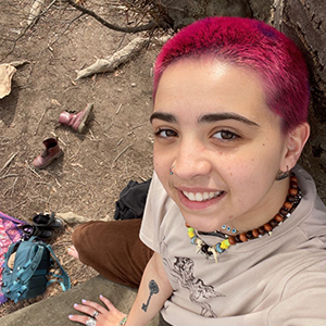 Woman with a short cut hairdo out in nature. 