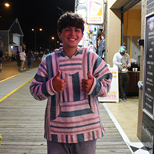 Man standing and giving a thumbs up. 