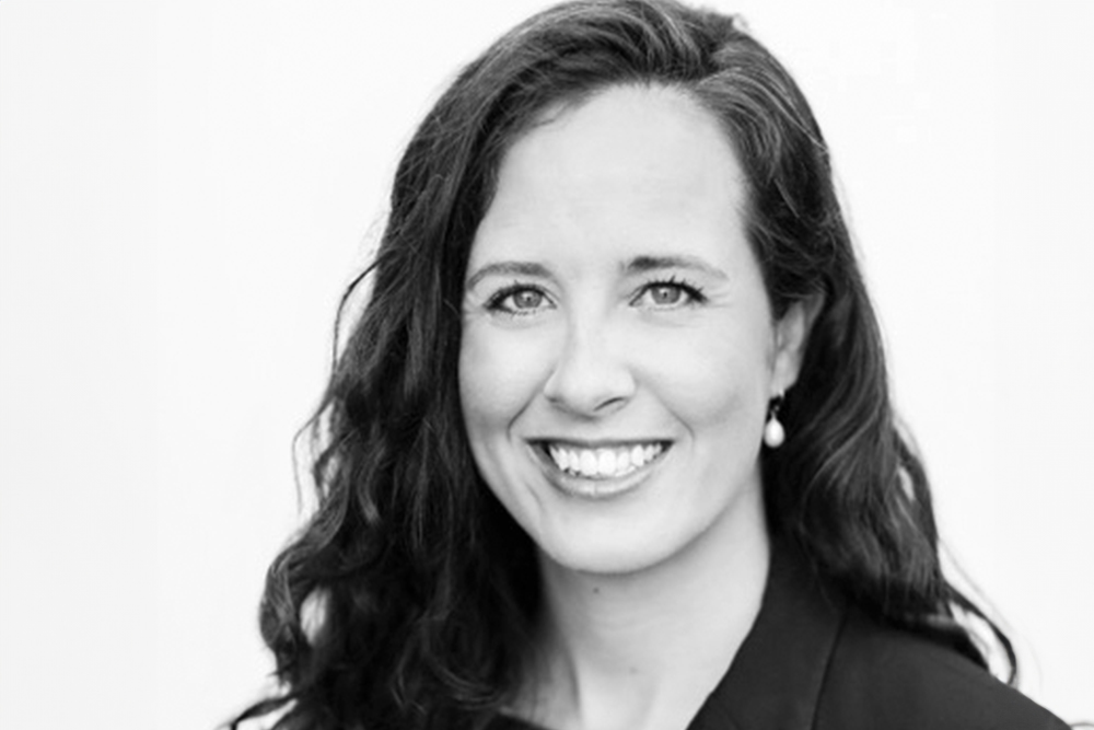 Smiling woman with dark hair. Photo in black and white