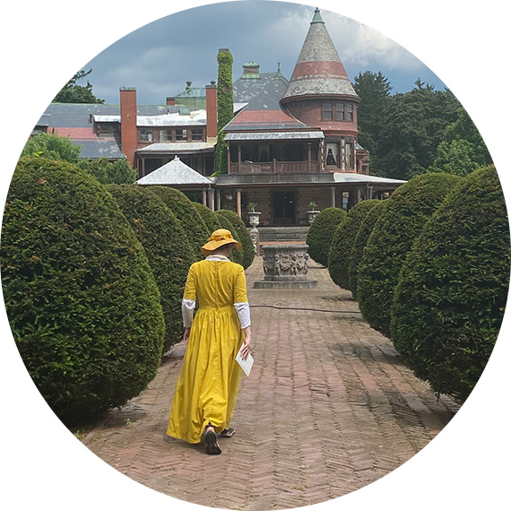 woman walking away wearing yellow dress.