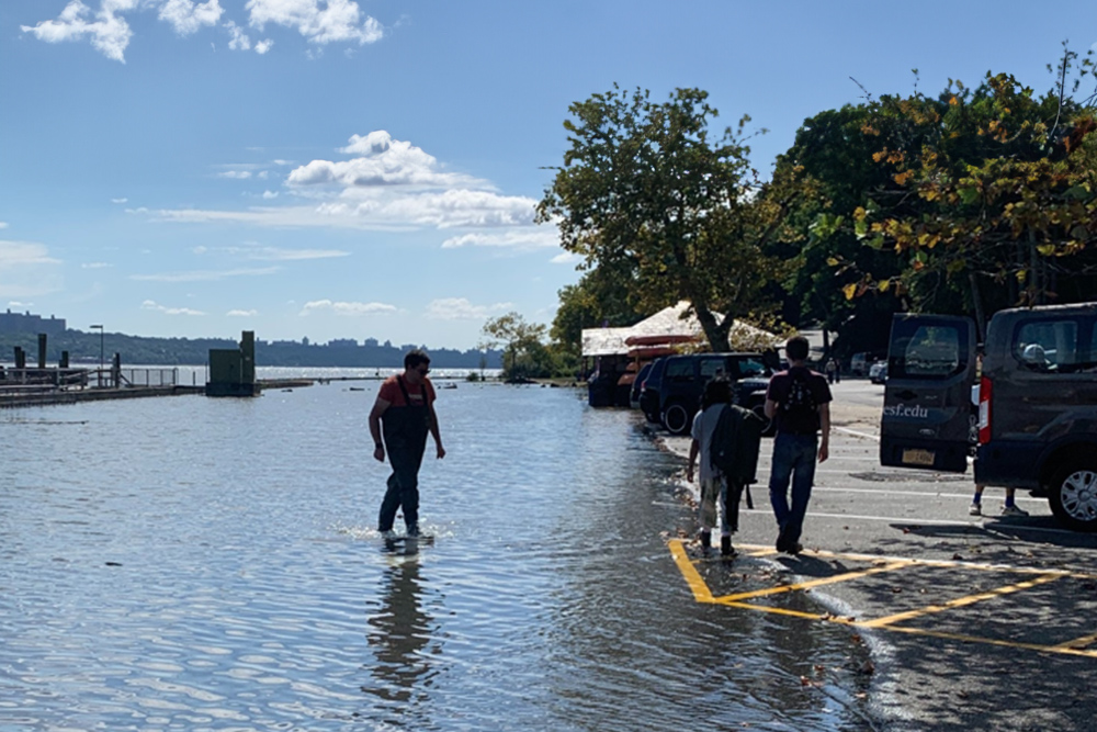 Person walking in flooded parking lot.