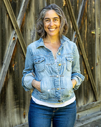 Marianne smiling with her hands in her jeans jacket pocket